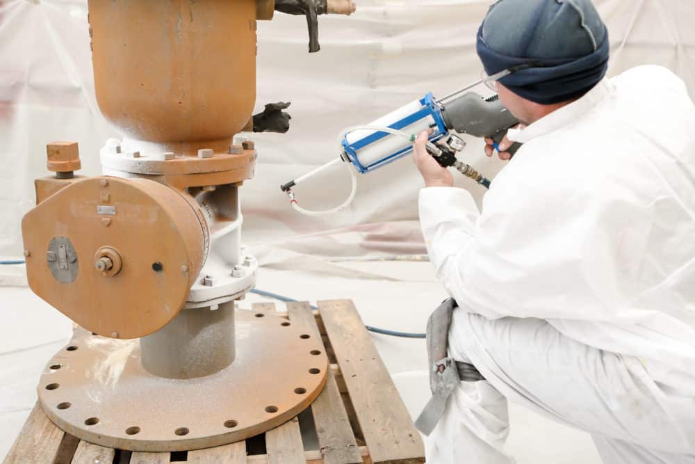 A worker from EonCoat applies their special two-layer coating for corrosion prevention