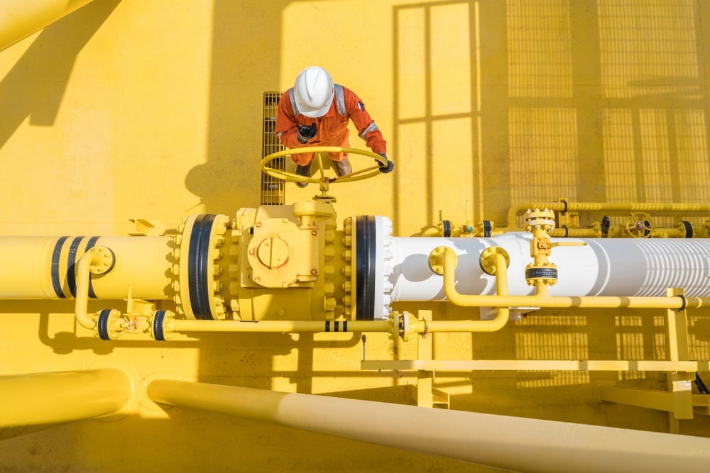 An energy worker working on a large platform