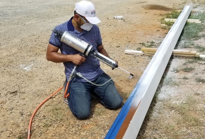 Sameer Patel applying EonCoat to railroad to permanently prevent corrosion